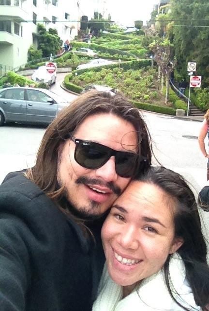 Me and my favorite travel partner and the Crookedest Street in the back .