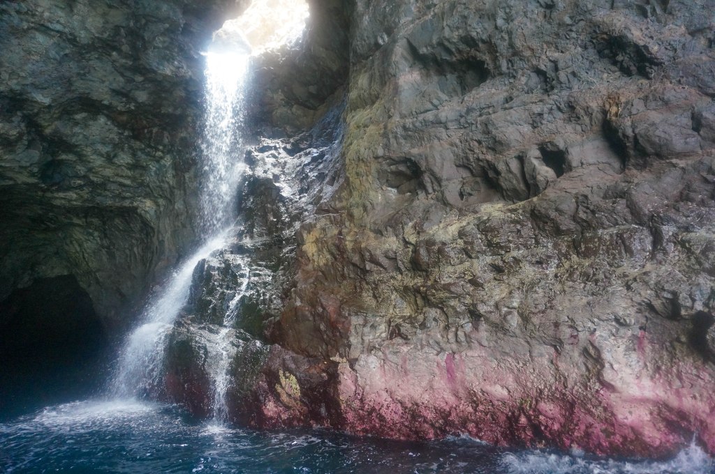 Waterfall flowing through the inside of sea cave.